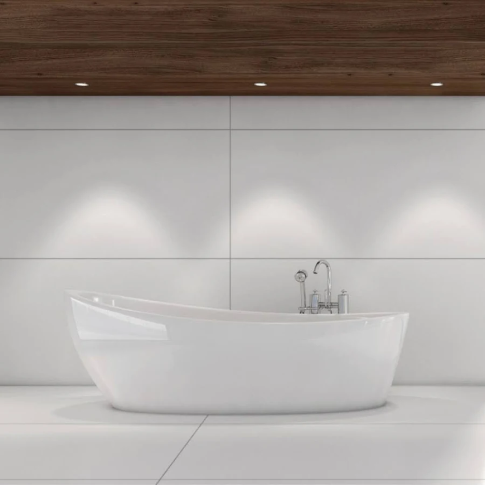 Large format white glossy wall tiles in a luxury bathroom with freestanding bath