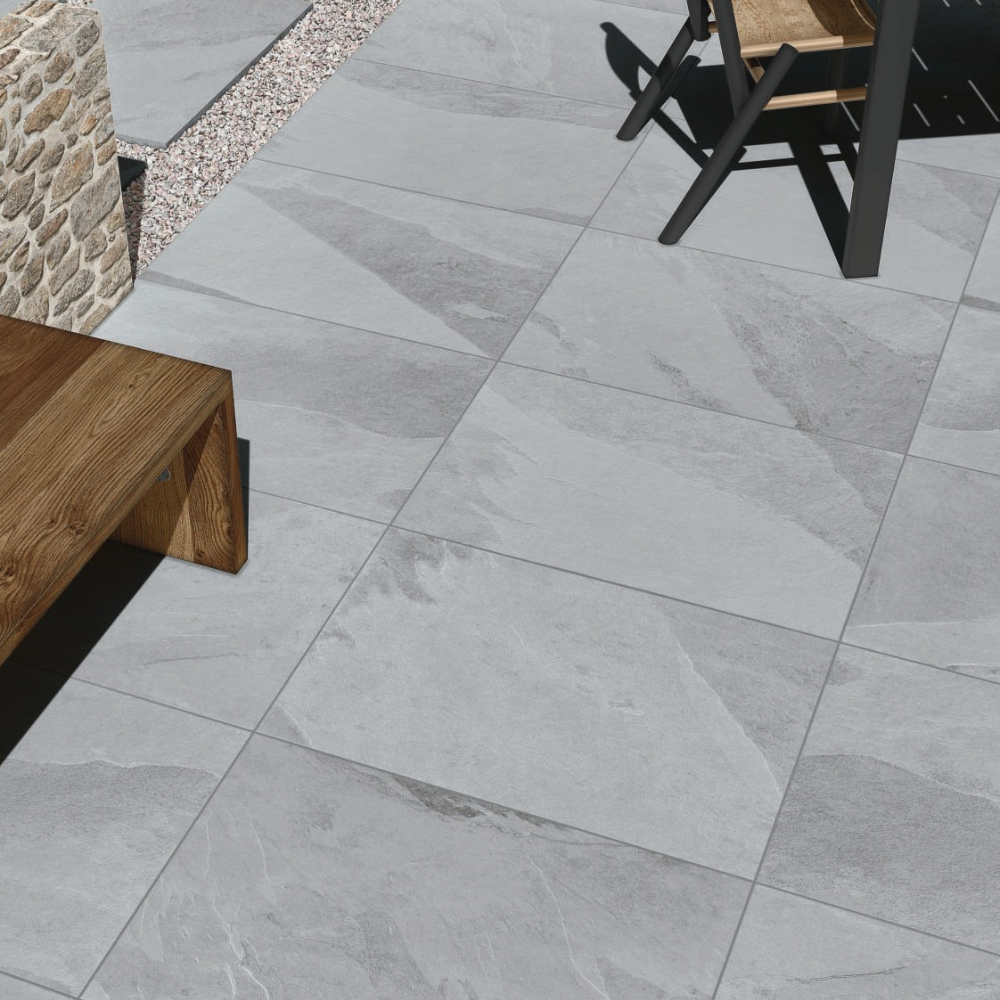 Gray tiled patio with wooden bench and chair