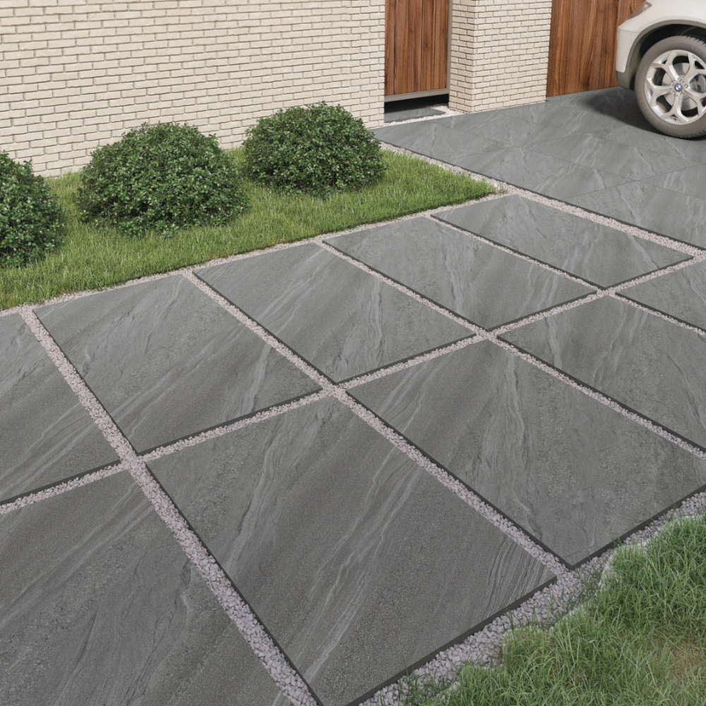Outdoor tiles in a natural stone finish, featuring a textured, slip-resistant surface in warm gray and beige tones.
