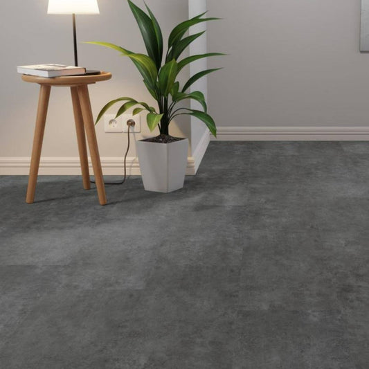 Gray carpeted room with a wooden side table and a plant.