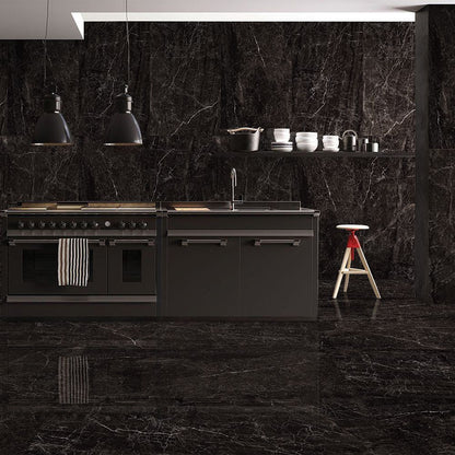 Modern kitchen with black marble walls and floor, featuring a stove and sink.