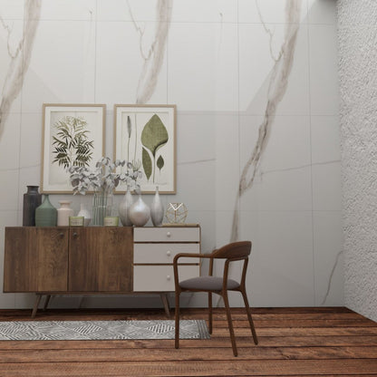 Modern interior with wooden sideboard, chair, and decorative items against a marble wall.